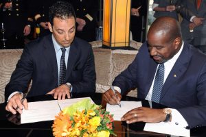 Fincantieri Shipyard Director Antonio Quintano and Orlando Ashford, president, Holland America Line sign papers for delivery of ms Koningsdam.