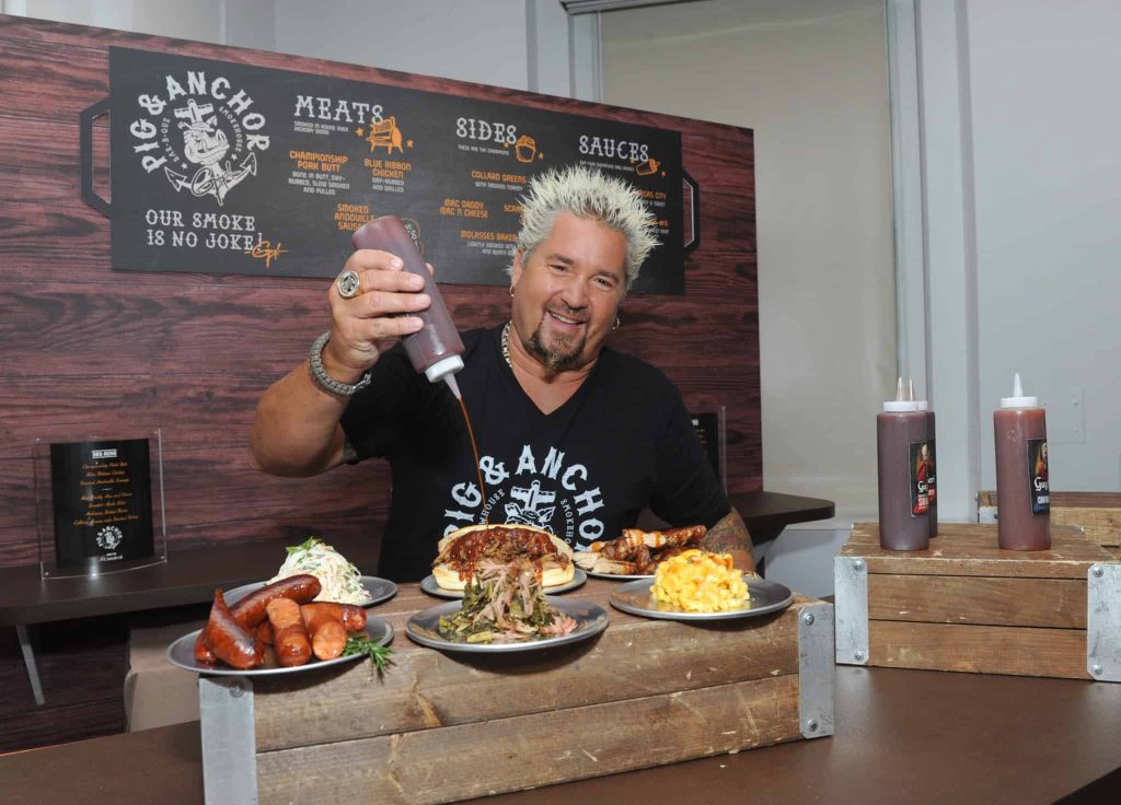 Food Network Star Guy Fieri serves up food from his new Pig & Anchor Bar-B-Que Smokehouse, exclusively on Carnival Cruise Line, at CarnivalÕs Summertime Beer-B-Que, Wednesday, July 27, 2016, in New York. (Diane Bondareff/ AP Images for Carnival Cruise Line)