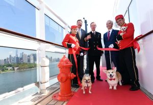 Richard Meadows, center left, President, Cunard, North America, Captain Christopher Wells, center, and David Noyes, center right, CEO, Cunard, joined by Cunard Kennel Masters, cut a ribbon to unveil the remastered kennels on the Queen Mary 2, the only passenger liner to carry pets, Wednesday, July 6, 2016, at Brooklyn Cruise Terminal in New York, its U.S. homeport.  The Queen Mary 2 spent 25 days in dry dock and a refit that cost in the region of $132 million, renovating its staterooms, restaurants and public areas.  (Diane Bondareff/AP Images for Cunard)