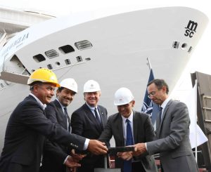 1. MSC Cruises executives, Mr Pierfrancesco Vago and Mr Gianni Onorato, open the valve with STX Director