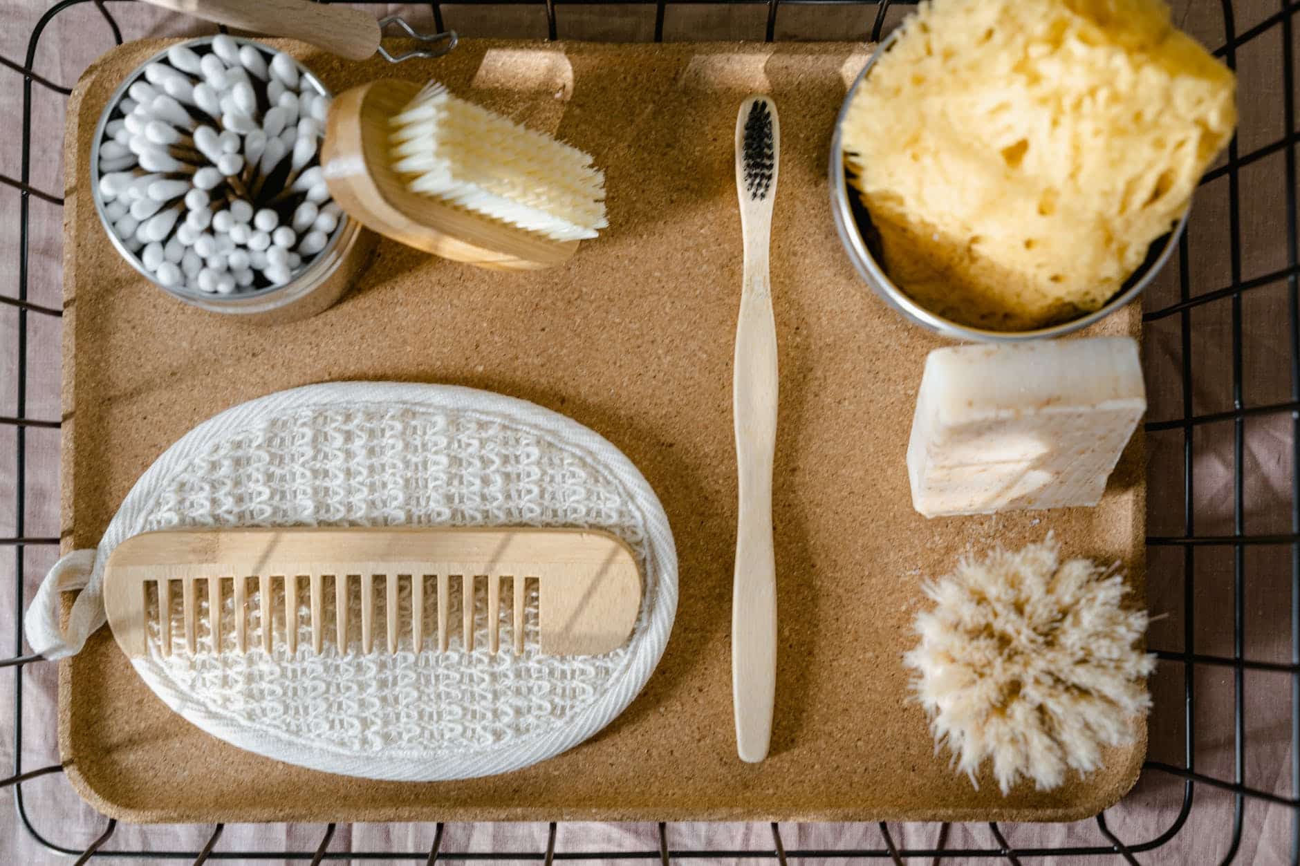 bathing essentials and toiletries on a wooden tray