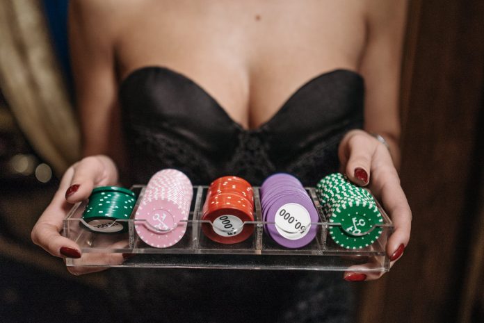 a person holding a tray of casino chips