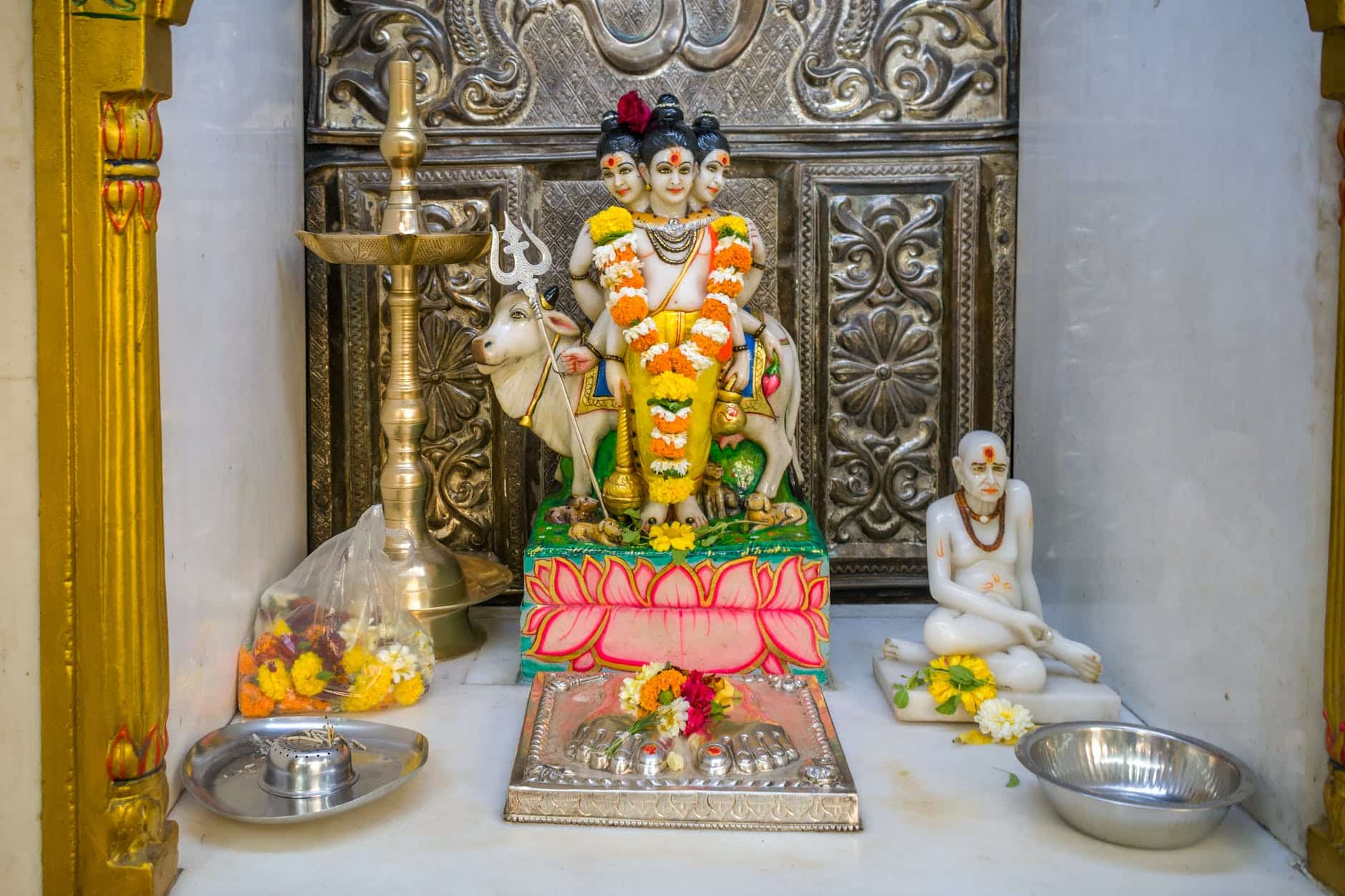 a statue of lord dattatreya at a hindu temple for the festival of datt jayanti in mumbai india