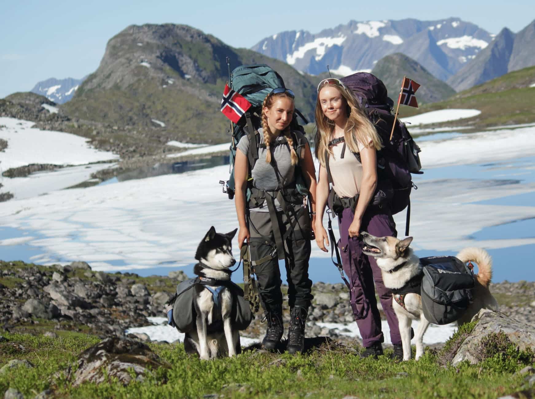 photo of two women with dogs while backpacking in the mountains